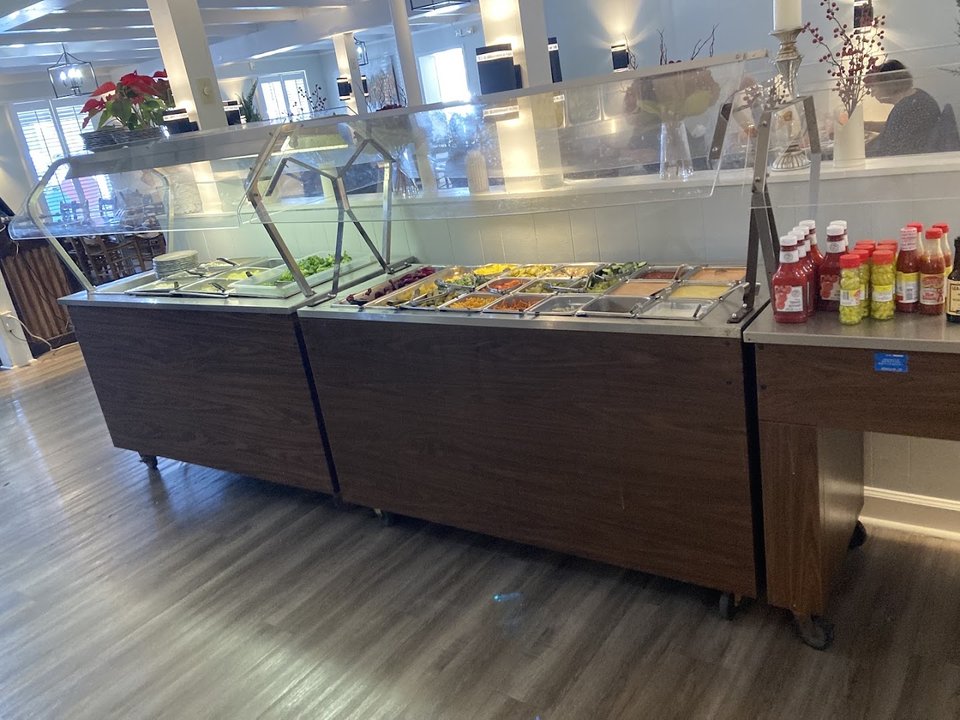 Buffet line with prepared seafood dishes.